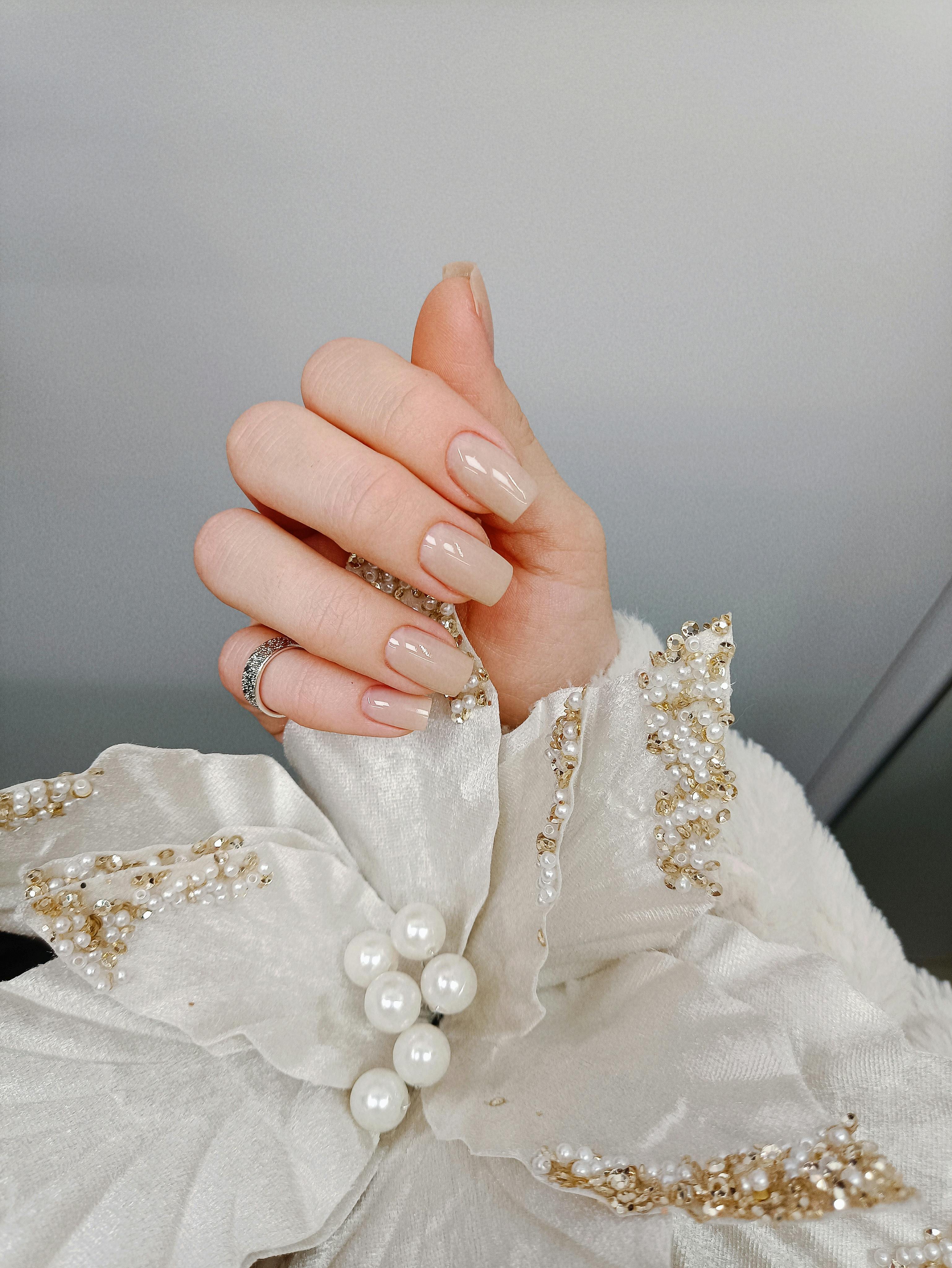 Free stock photo of a nude manicure with pearl details used as a demo image
